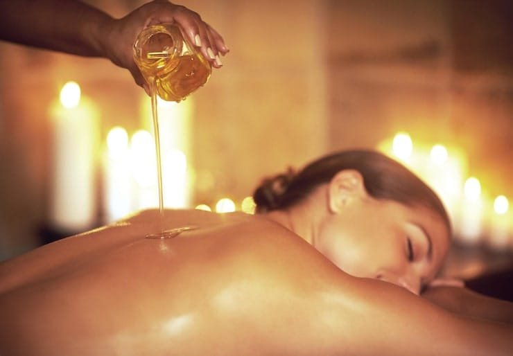 Aromatic massage oil being poured for a massage.