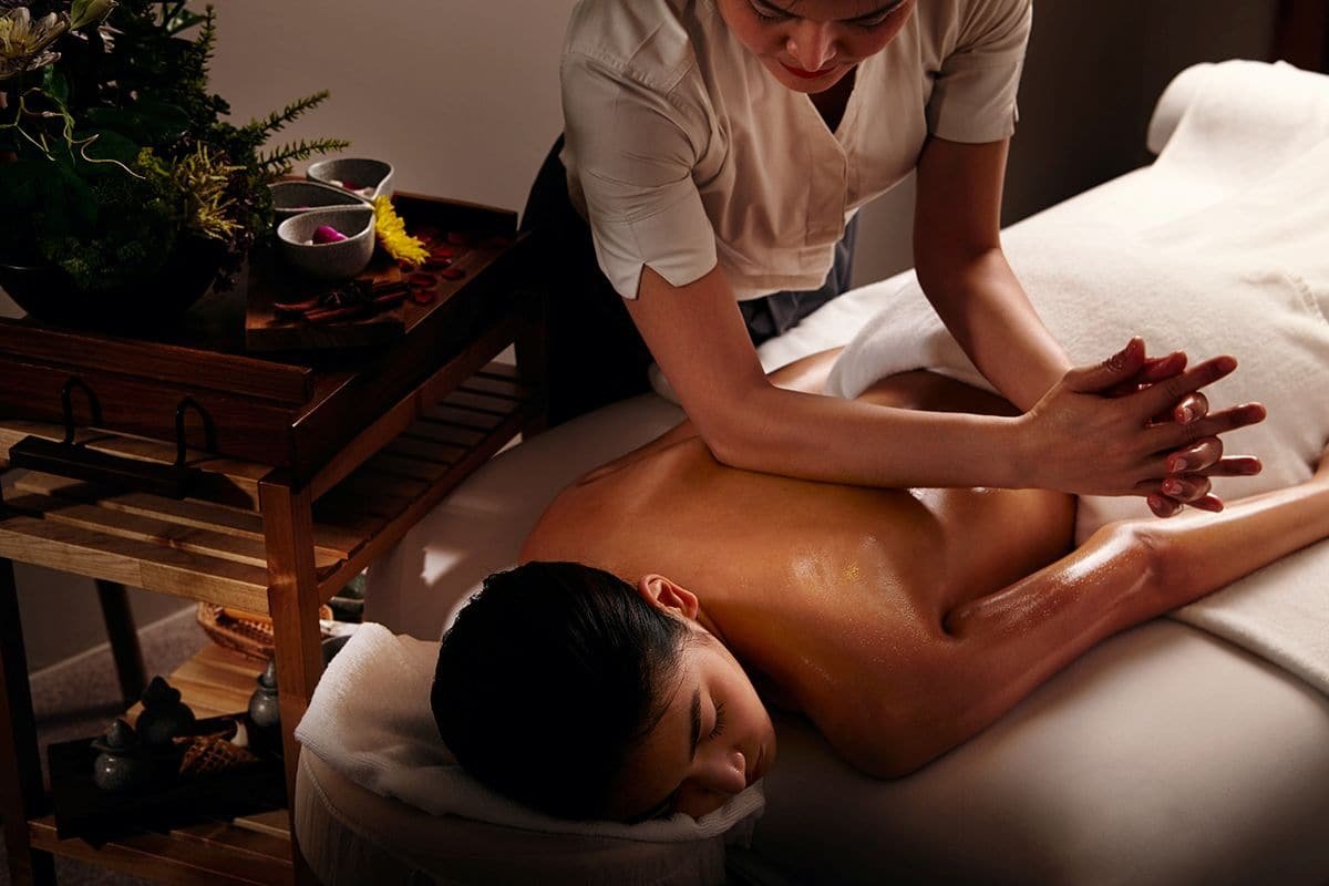 Therapist using forearm pressure during a back massage.